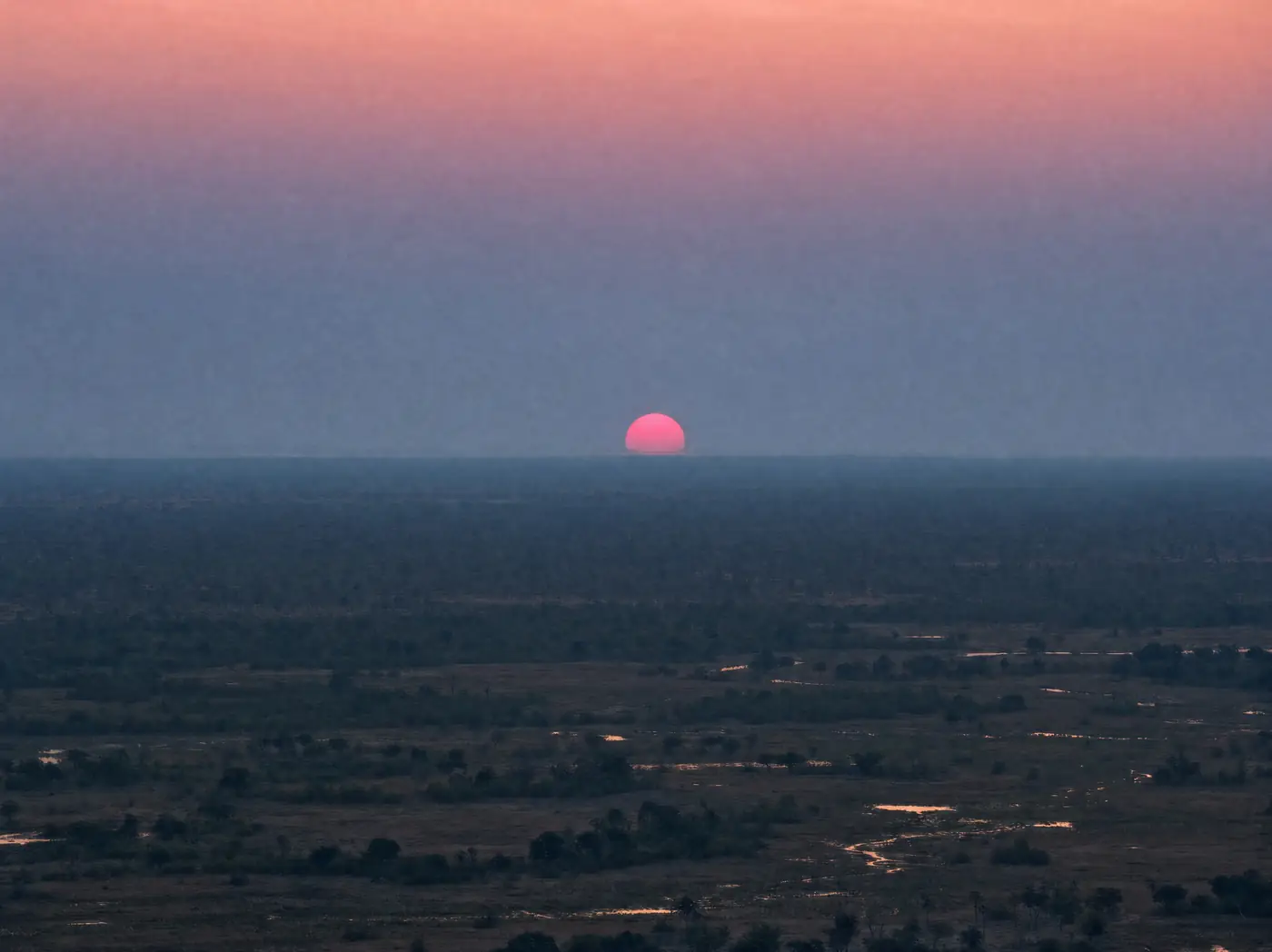 A red sun low over the Delta at dusk