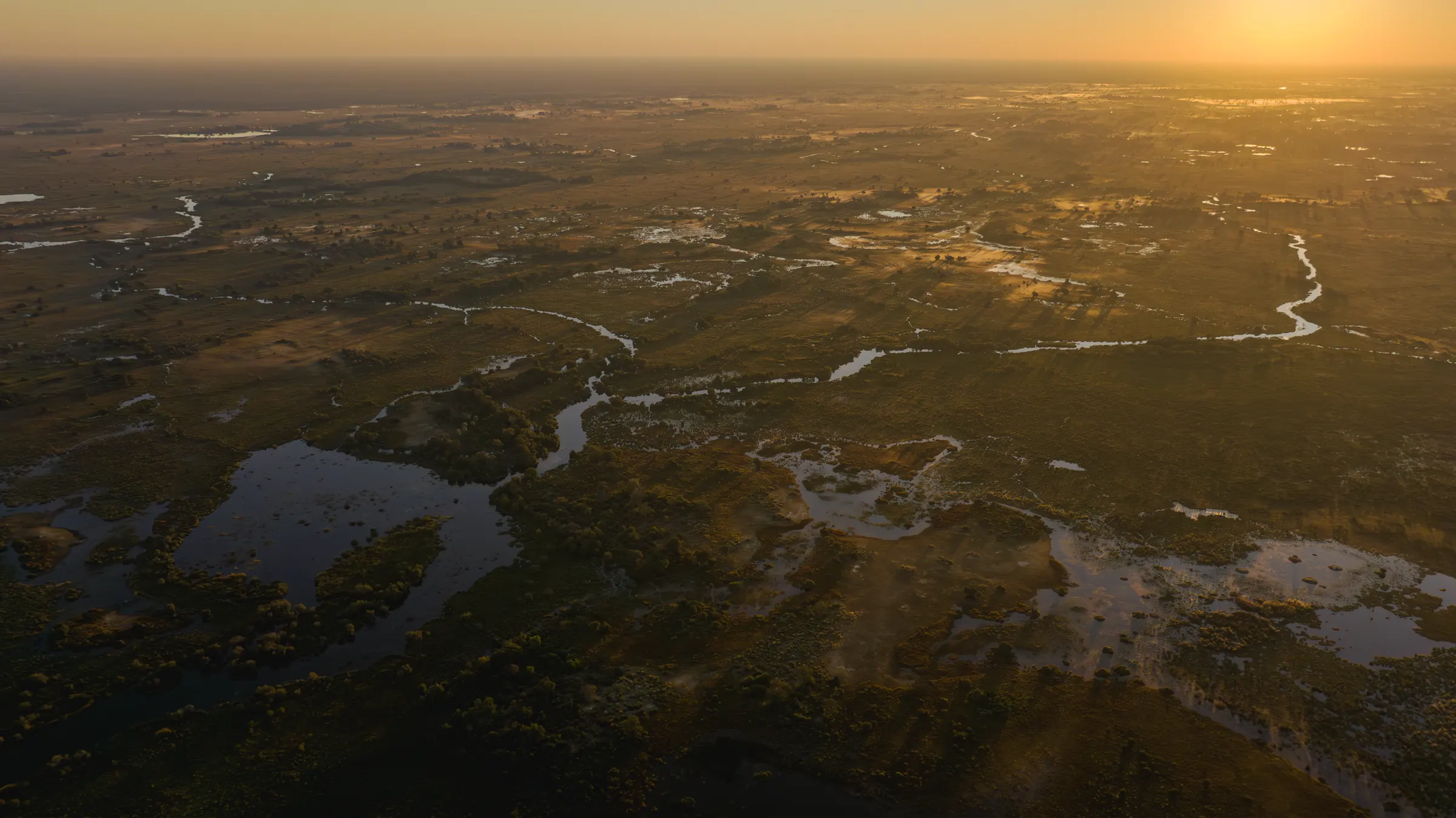 Water spreading through the floodplains at sunrise, seen from the air