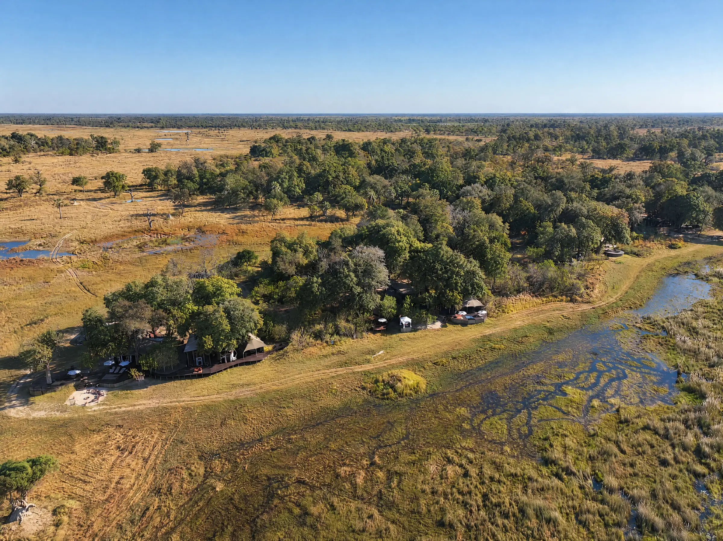 Elo's island from the air, the villas among the trees and a channel beside it