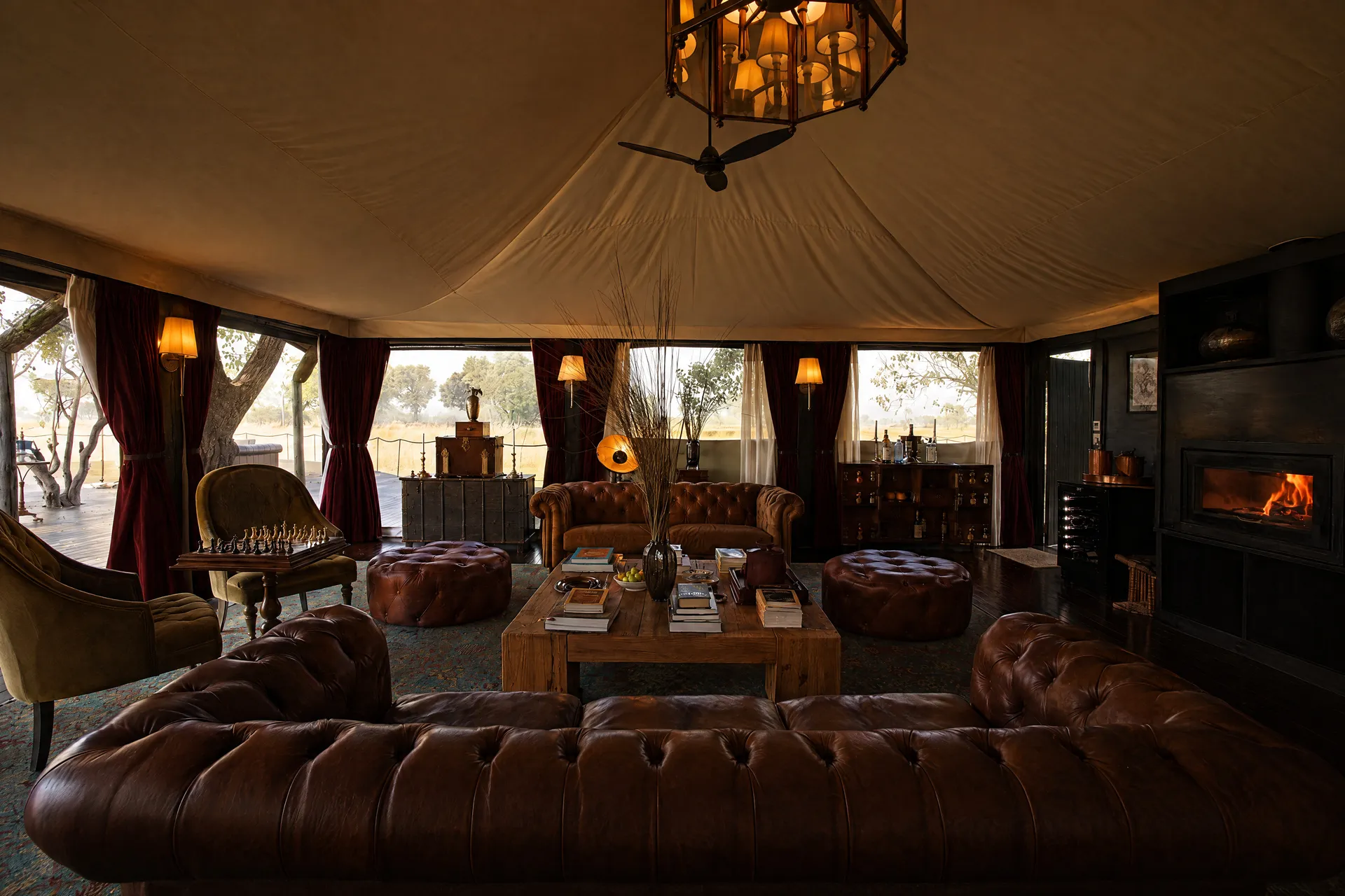 The villa living room: chesterfield sofas, a chandelier and the fire lit