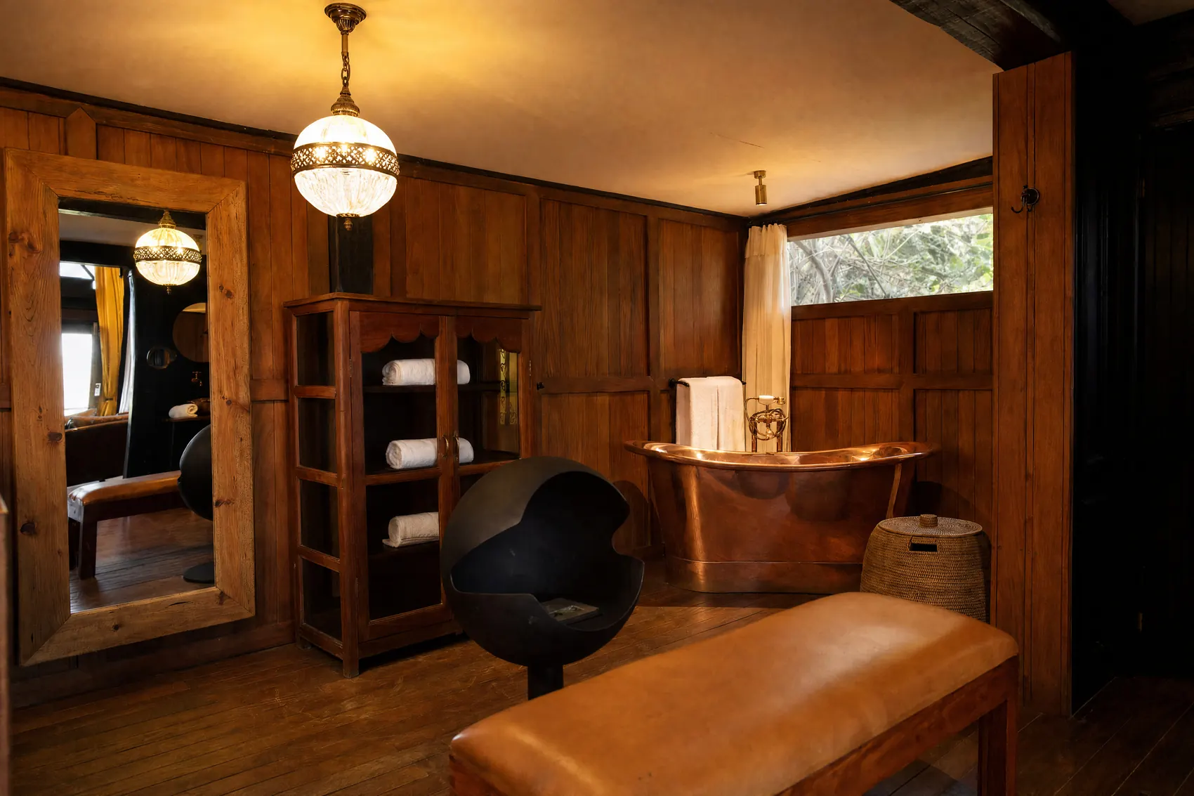 The wood panelled bathroom with the copper tub