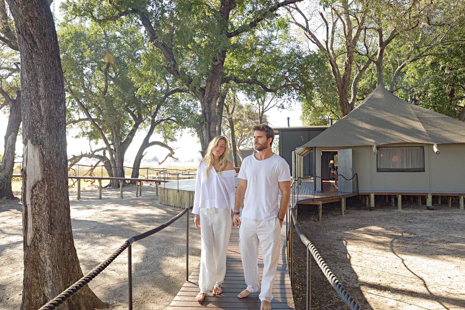 Two guests walking the boardwalk back to the villa
