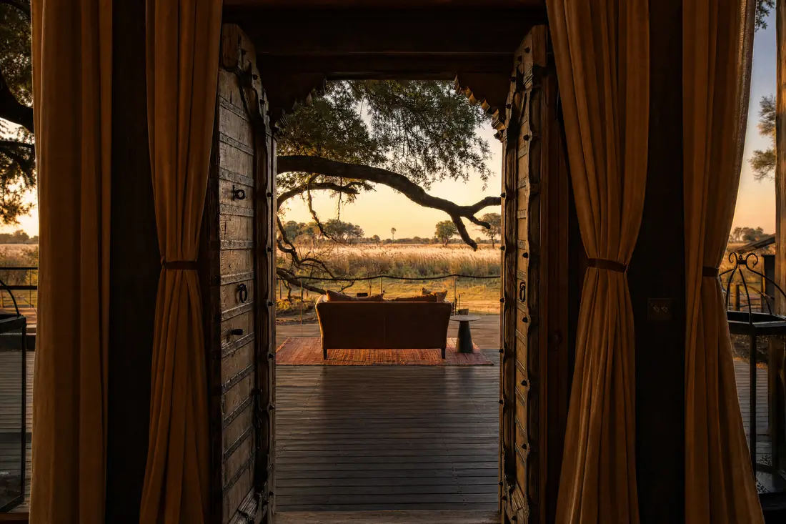 Carved doors opening from the villa onto the deck