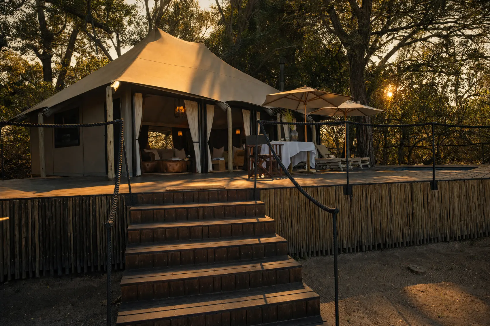 The lounge house under its canvas roof, with timber steps up to the deck